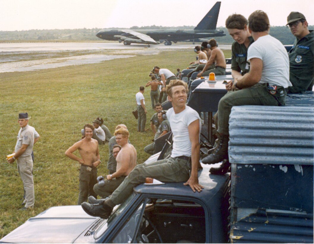 Taking a moment out of their exhausting schedules, Airmen from the Consolidated Aircraft Maintenance Wing watch as a wave of B-52s take off en route for targets over North Vietnam. (Courtesy photo)