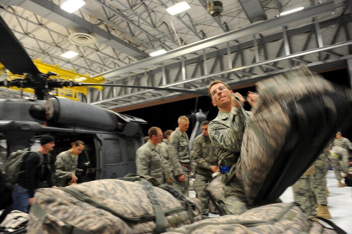 Technical Sgt. David Brown, a flightline expeditor assigned to the 763rd Maintenance Squadron, hauls mobility bags from the units deployment, at Nellis Air Force Base, Nev., Dec. 6, 2008. The 763rd MXS and 66th Rescue Squadron Airmen, return home after 3 1/2 months in Southwest Asia, supporting the Global War on Terrorism.
(U.S. Air Force Photo/Senior Airman Larry E. Reid Jr.)
