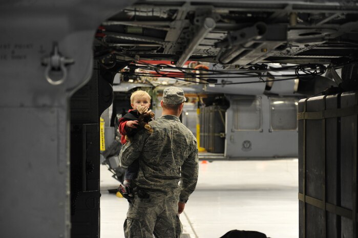 Senior Airman Matthew Ohara, an HH-60 crew chief assigned to the 763rd Maintenance Squadron, holds his son Jacob Ohara, 2, as he peers through the back of an HH-60 at Nellis Air Force Base, Nev., Dec. 6, 2008. The 763rd MXS and 66th Rescue Squadron Airmen, return home after 3 1/2 months in Southwest Asia, supporting the Global War on Terrorism.
(U.S. Air Force Photo/Senior Airman Larry E. Reid Jr.)