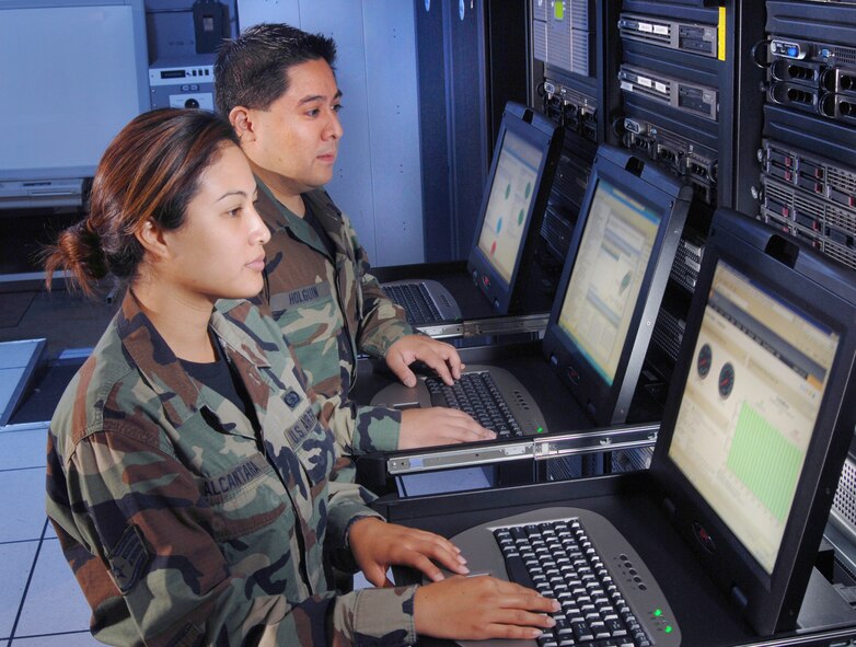 Master Sgt. Ramon Holquin, and Staff Sgt. Melissa Alcantara, computer systems operators assigned to the 163rd Communications Flight, use network servers to load security patches and monitor network usage of personnel with the Wing and geographically separated units at March ARB. The mission of the 163 RW is to safely execute global unmanned aerial systems, combat support, and humanitarian missions by highly trained, professional Air National Guard men and women. (U.S. Air Force photo by Val Gempis)