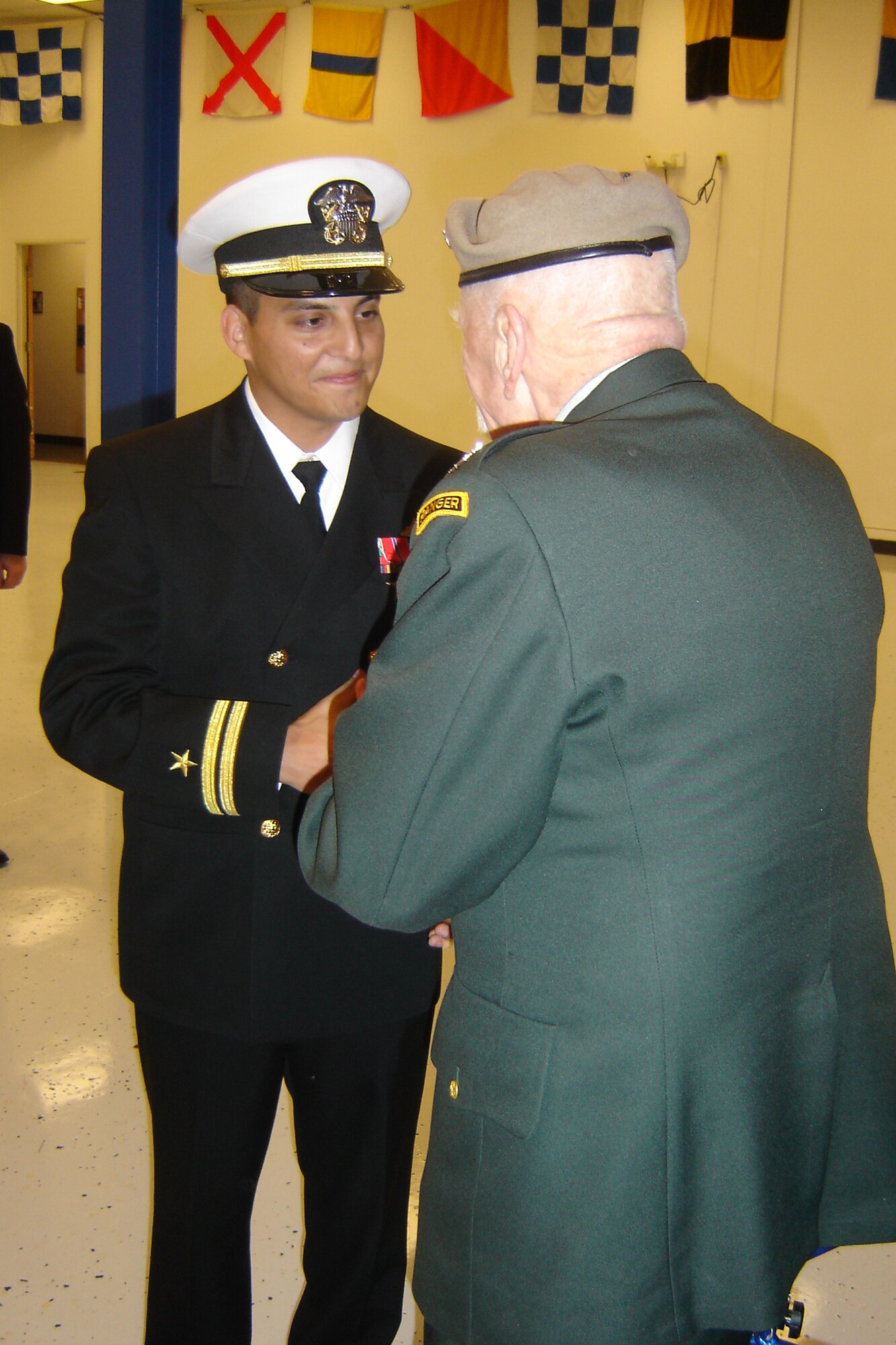 Medal of Honor recipient Col. Lewis L. Millett presents the Bronze Star to U.S. Navy Lieutenant Ed Giron, NOSC executive officer, for his service in Iraq. (U.S Air Force photo by Will Alexander)