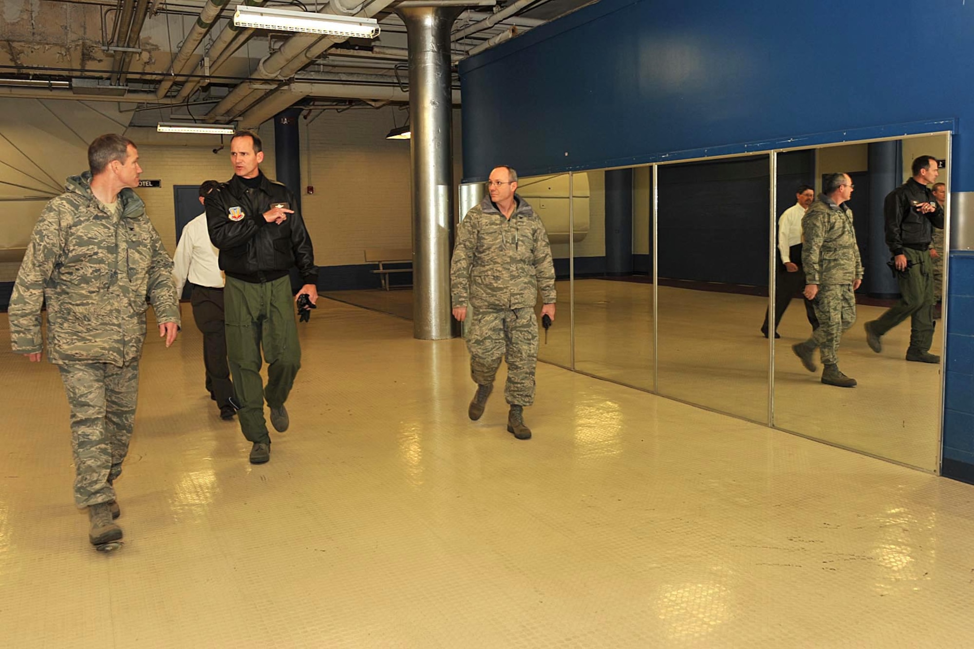 OFFUTT AIR FORCE BASE, Neb. -- Col. Thomas Goffus, 55th Mission Support Group commander, and Mr. Mark Jacobsen, 55th Civil Engineer Squadron director of engineering, show Brig. Gen. James Jones, 55th Wing commander, and Col. Rob Maness, 55th Wing vice commander, around the Martin Bomber Building. OFFUTT AIR FORCE BASE, Neb. -- Brig. Gen. James Jones, 55th Wing commander, dicusses the recent cleanup efforts at the Martin Bomber Building with Staff Sgt. Aaron Molchak, 55th Wing Honor Guard non-commissioned officer in charge. The building has undergone extensive cleanup efforts since March in order to improve the work environment for many military and civilian members of Team Offutt. This historic building consists of 1.5 million square feet and was used as a plant for B-26 Marauder Bombers and B-29 Superfortress Bombers during World War II.   (U.S. Air Force Photo By Charles Hammond)