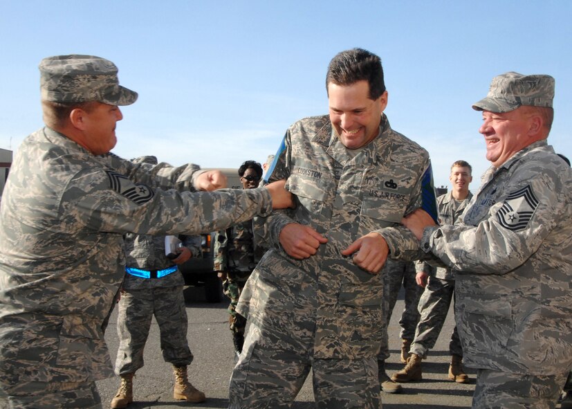 Chief Master Sergeant Paul Maynard (60th Aerial Port Squadron), left, and Chief Master Sergent Tim Veen ( 60th Aerial port Squadron), right, tack chief master sergeant stripes on Senior Master Sergeant Curtis Cookston (615th Contingency response Wing) on Nov 12th 2008. Nine Travis Senior Master Sergeants were selected for promotion to Chief this year. (USAF photo by Amanda Lopez/Civ) (Released)  