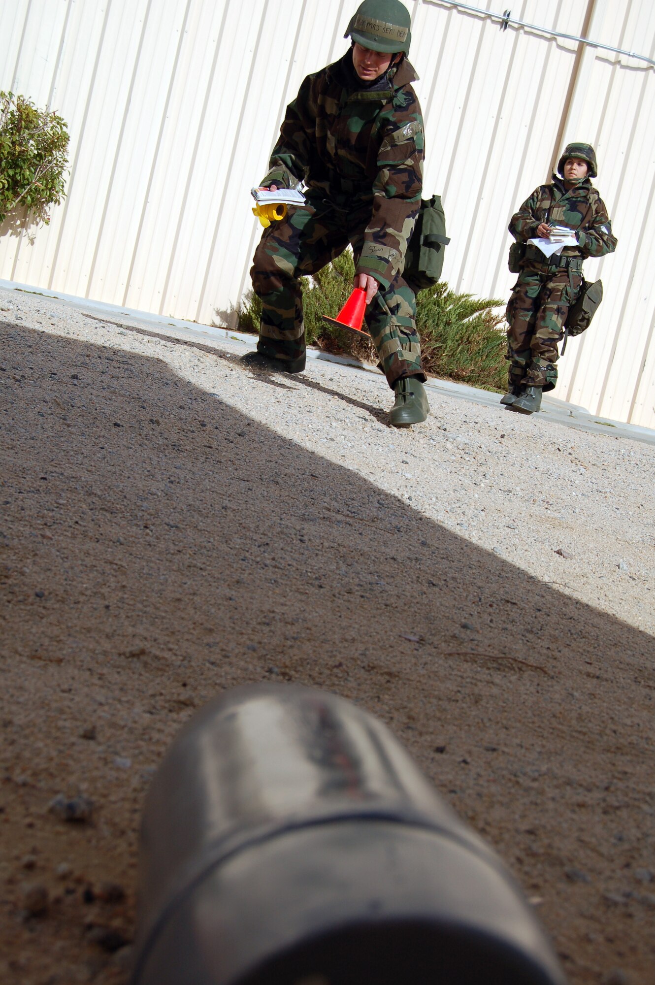 Maj. Seth Deam, Air Force Flight Test Center legal office chief of military justice, marks an unexploded ordnance Dec. 4 during Phase II of the Operational Readiness Exercise. Team Edwards performed its last ORE and Emergency Management Exercise Dec. 2 to 5 before the upcoming Unit Compliance Inspection in January. (Air Force photo by Senior Airman Julius Delos Reyes)