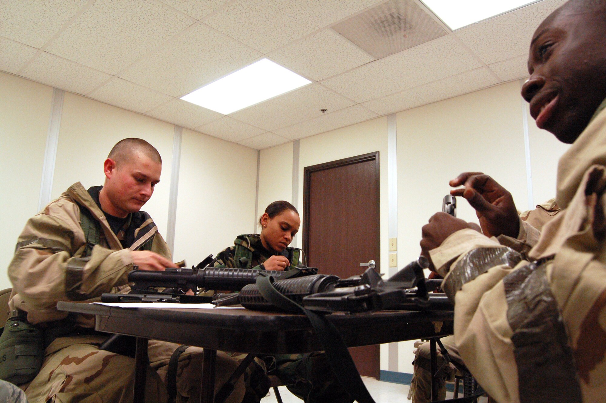 Edwards Airmen disassemble M-16 rifles during a weapons familiarization training for the Operational Readiness Exercise Dec. 4 at the Mobility Processing Center. This is in preparation for the upcoming Unit Compliance Inspection in January. (Air Force photo by Senior Airman Julius Delos Reyes)