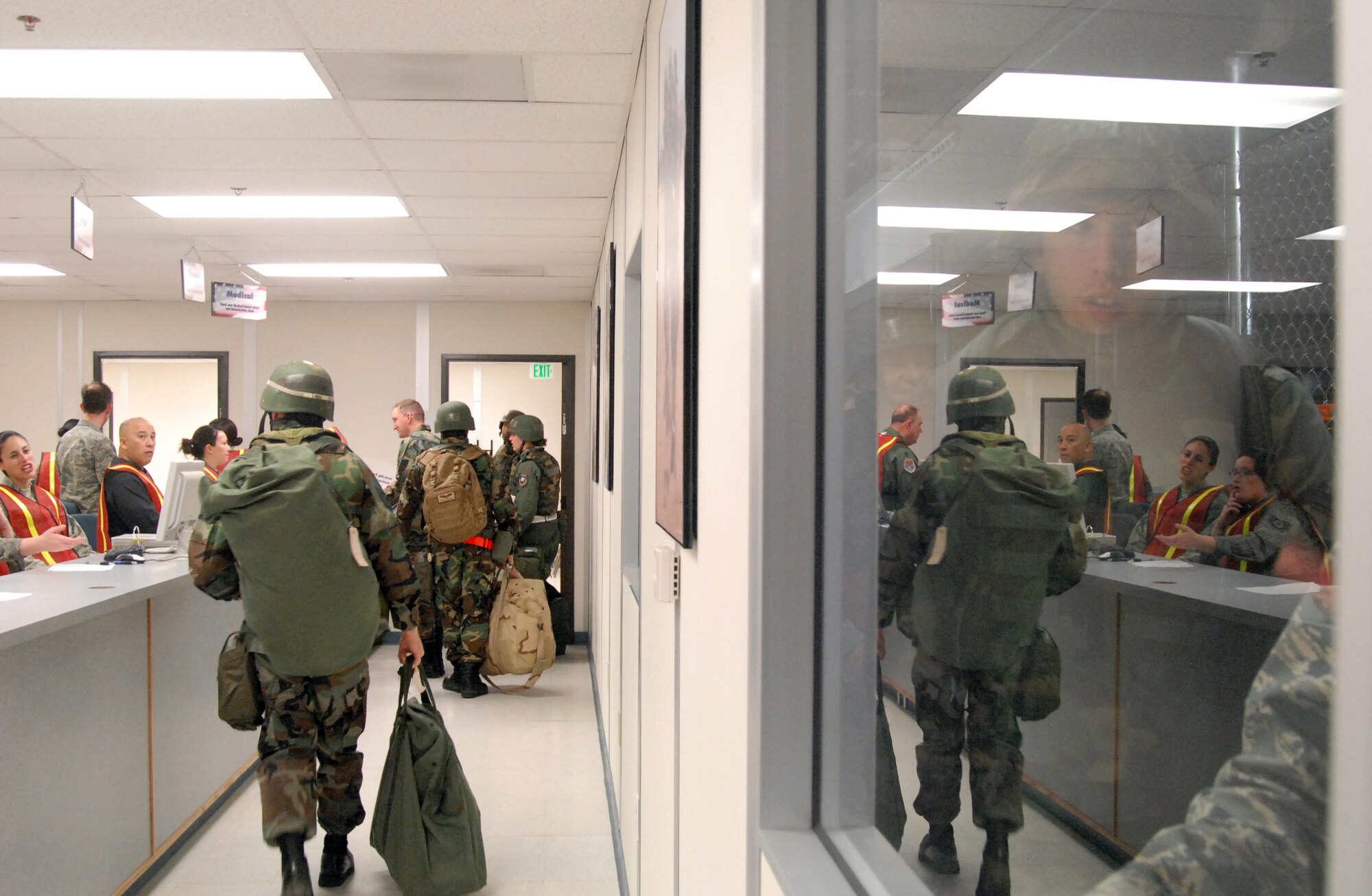 Edwards Airmen go through the processing line during an exercise at the Mobility Processing Center Dec. 2. Ninety-nine Airmen participated in the Phase I and II exercise in preparation for the upcoming unit compliance inspection. (Air Force photo by Senior Airman Julius Delos Reyes)
