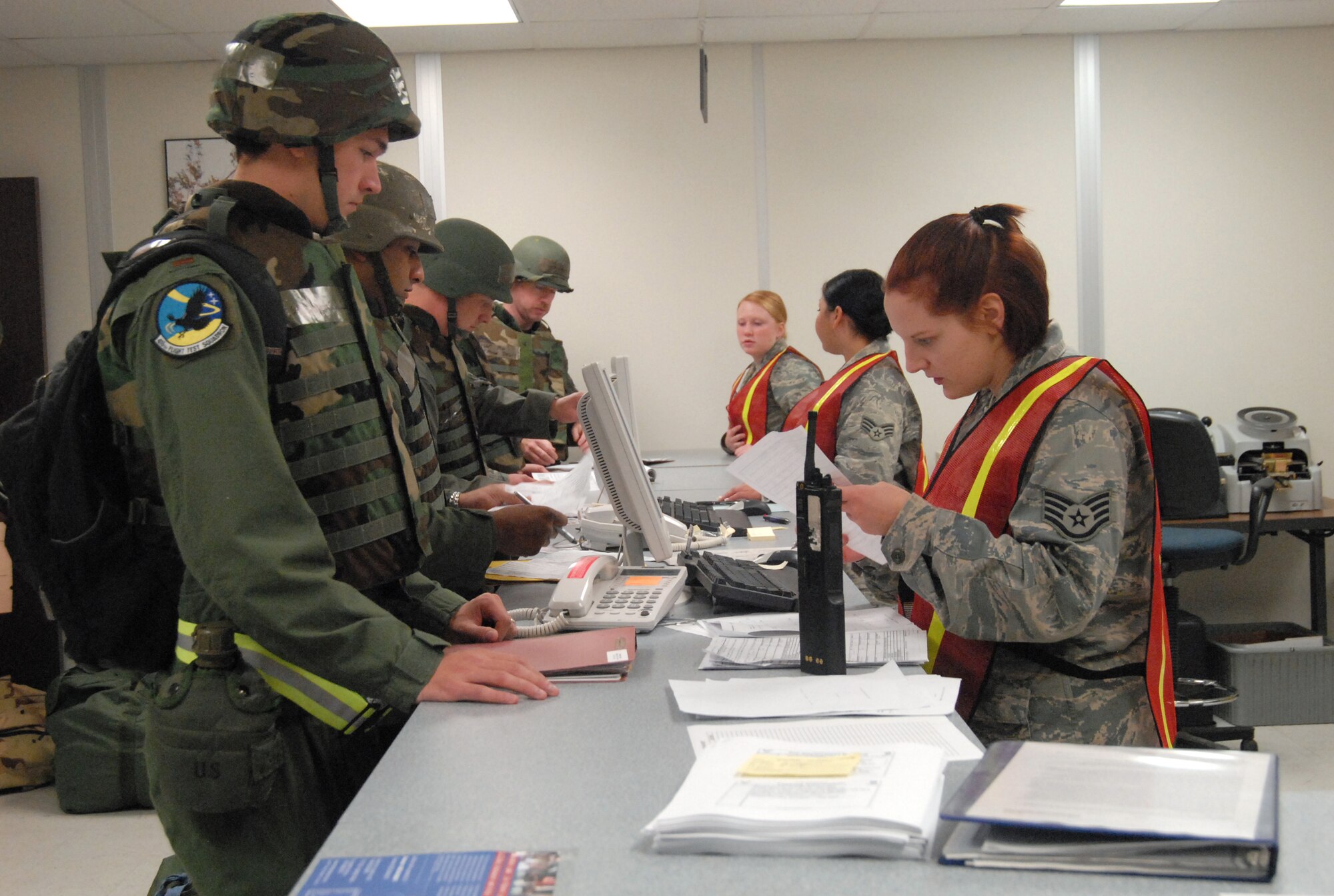 Edwards Airmen go through the processing line during an exercise at the Mobility Processing Center Dec. 2. Ninety-nine Airmen participated in the Phase I and II exercise in preparation for the upcoming unit compliance inspection. (Air Force photo by Senior Airman Julius Delos Reyes)