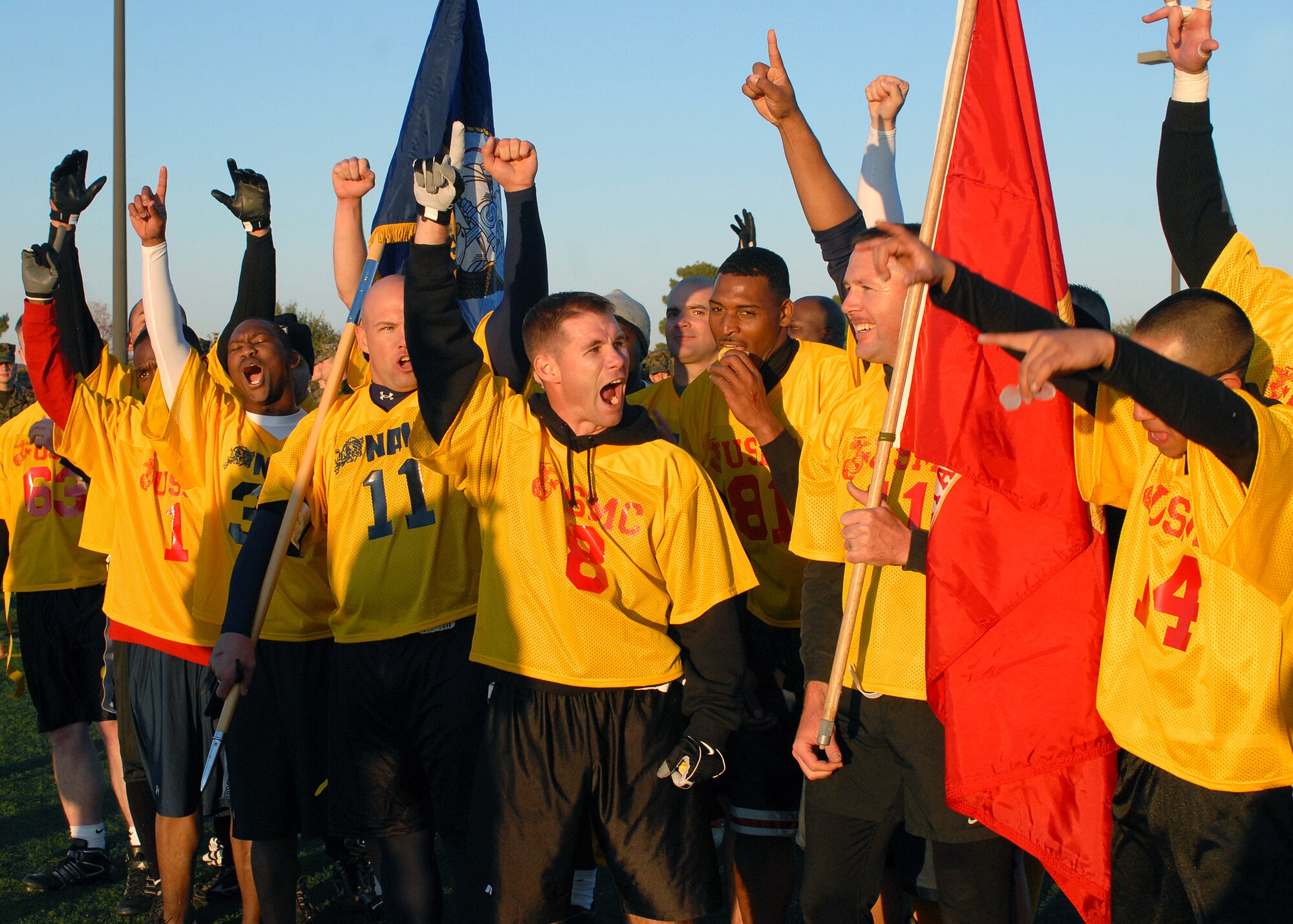 Members of the Navy team celebrate their victory in the annual Army vs. Navy flag football game at Goodfellow Air Force Base on Dec. 5.  Navy defeated Army for the first time in 5 years with a score of 49-47.  (U.S. Air Force photo by Senior Airman Kasabyan Musal).
