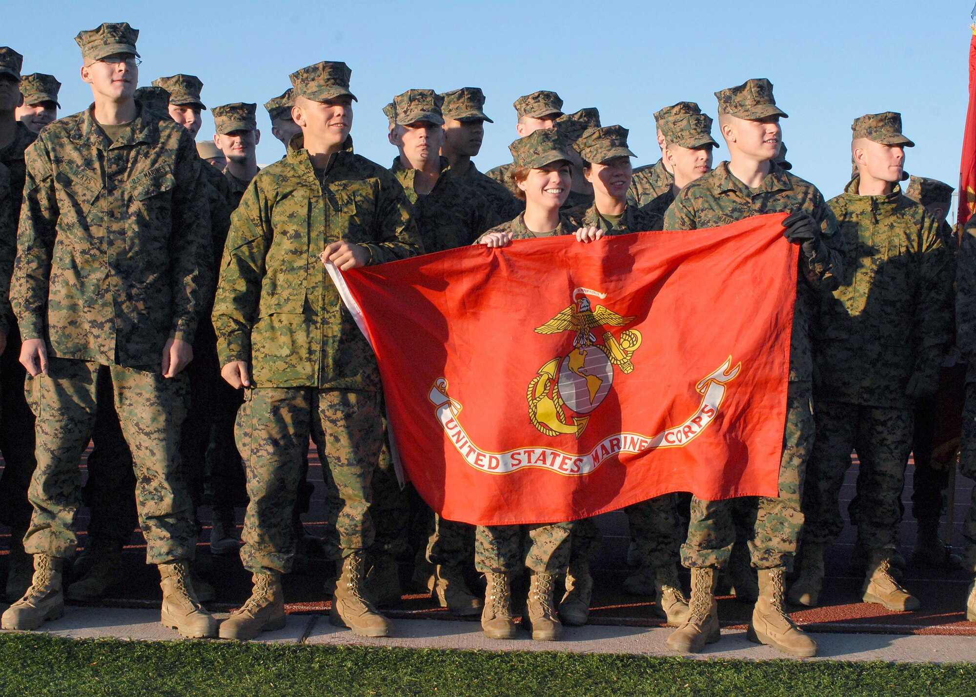 Members of the Goodfellow Marine Corps Detachment cheer on the Navy team during the annual Army vs. Navy flag football game at Goodfellow Air Force Base on Dec. 5.  Navy defeated Army for the first time in 5 years with a score of 49-47.  (U.S. Air Force photo by Senior Airman Kasabyan Musal).

