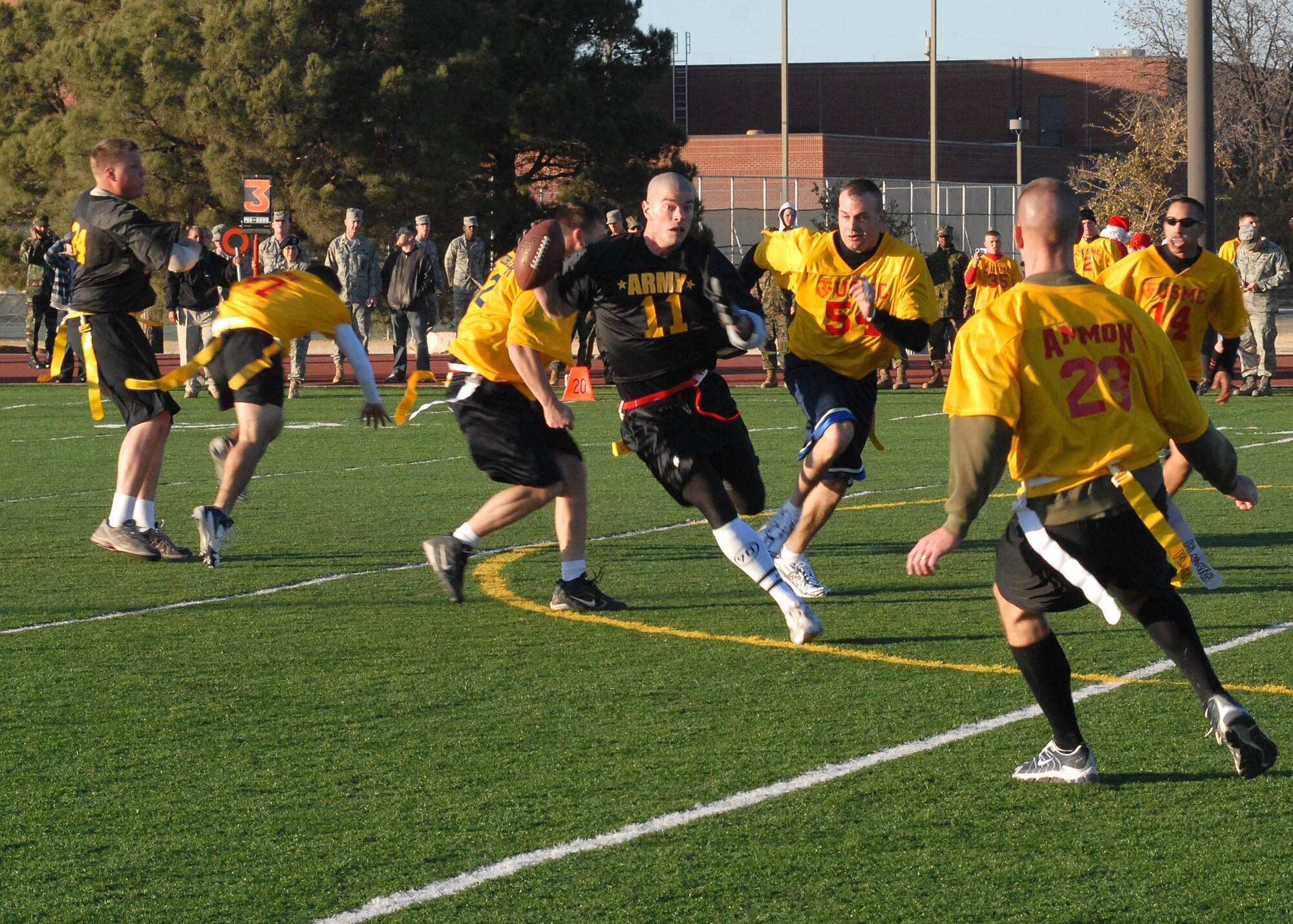 An Army player attempts to outmaneuver the Navy team during the annual Army vs. Navy flag football game at Goodfellow Air Force Base on Dec. 5.  Navy defeated Army for the first time in 5 years with a score of 49-47.  (U.S. Air Force photo by Senior Airman Kasabyan Musal).
