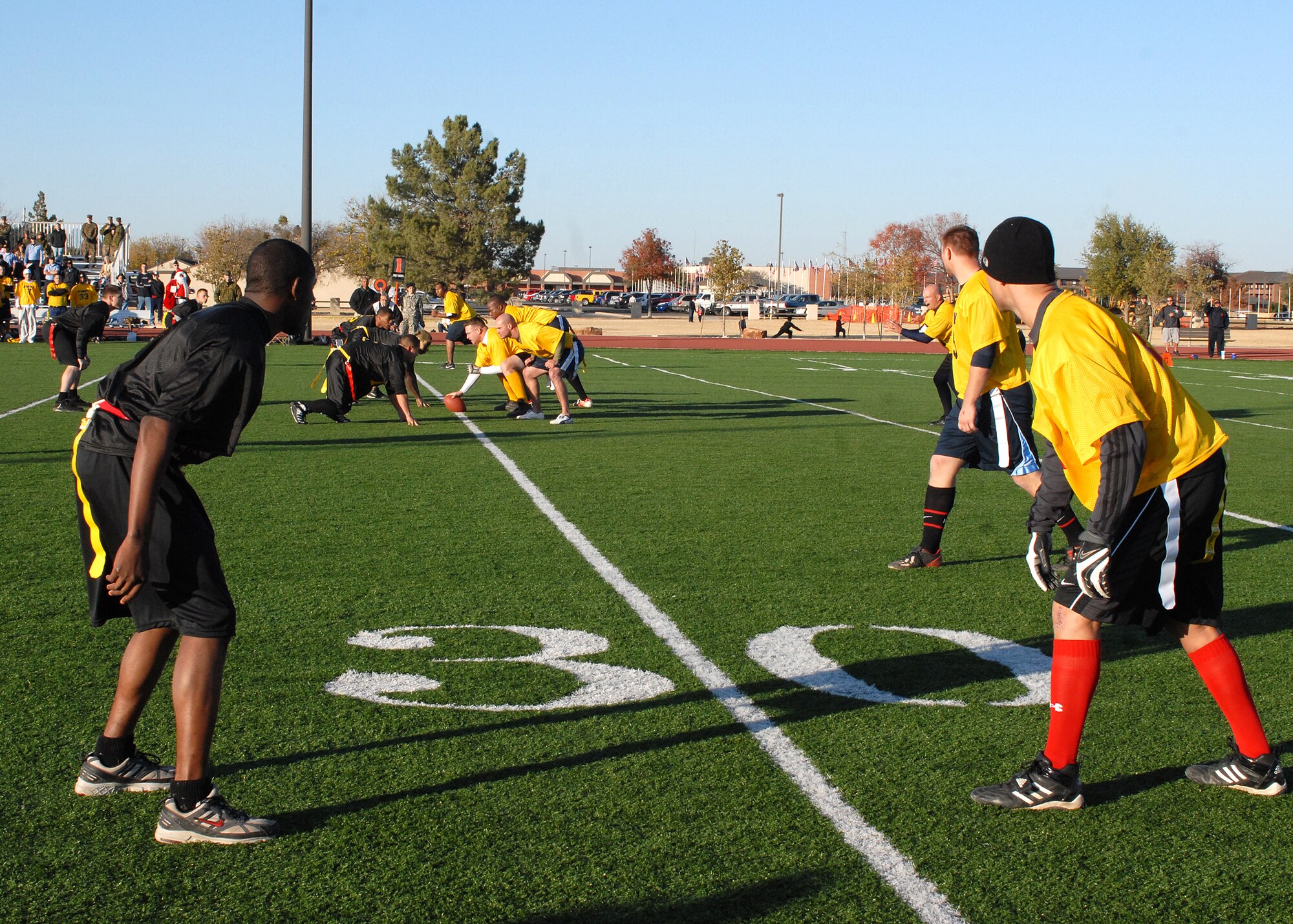 The Navy prepares to make the next play as the Army defense stands ready during the annual Army vs. Navy flag football game at Goodfellow Air Force Base on Dec. 5.  Navy defeated Army for the first time in 5 years with a score of 49-47.  (U.S. Air Force photo by Senior Airman Kasabyan Musal).
