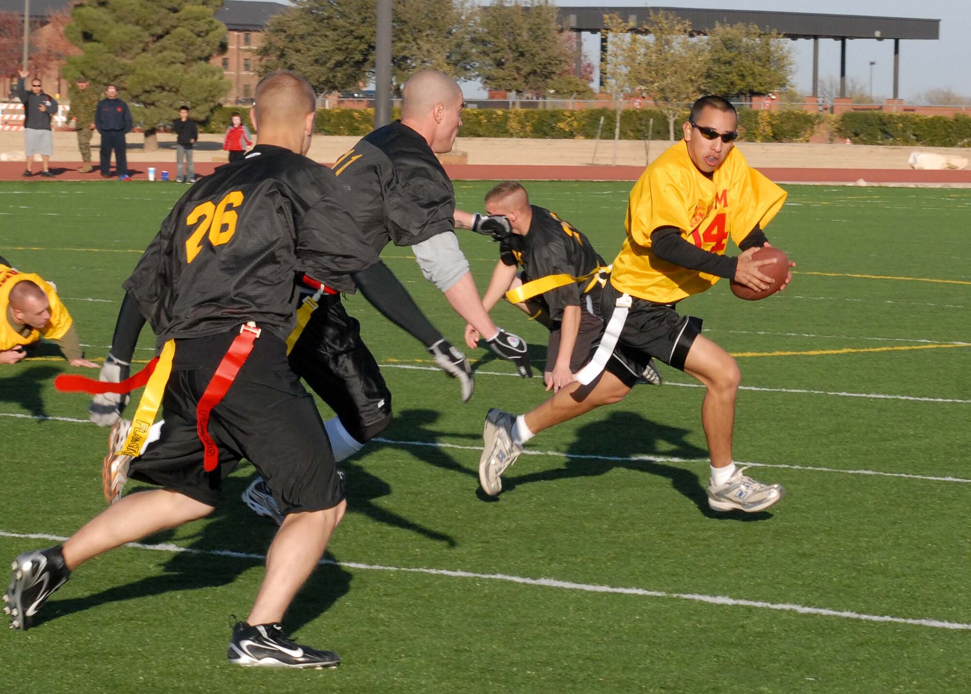 A Navy player attempts to outmaneuver the Army team during the annual Army vs. Navy flag football game at Goodfellow Air Force Base on Dec. 5.  Navy defeated Army for the first time in 5 years with a score of 49-47.  (U.S. Air Force photo by Senior Airman Kasabyan Musal).
