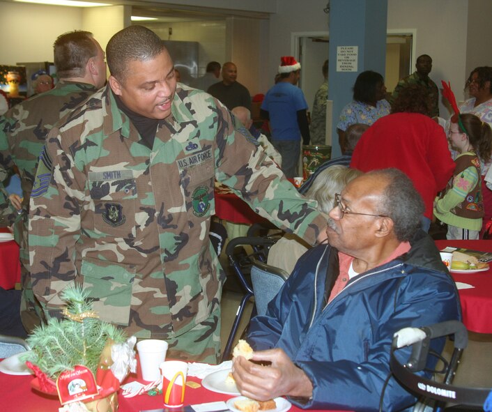 WRIGHT-PATTERSON AFB, Ohio - Chief Master Sgt. Joseph Smith, 445th Maintenance Squadron first sergeant, visits with Mr. Augustus Morris, who is his father -in-law, at the Dayton VA Medical Center in Dayton, Ohio during the annual Christmas party.  The 445th Airlift Wing has been involved with the VA Christmas celebration for 12 years. (Air Force photo/Capt. Caroline Wellman)  
