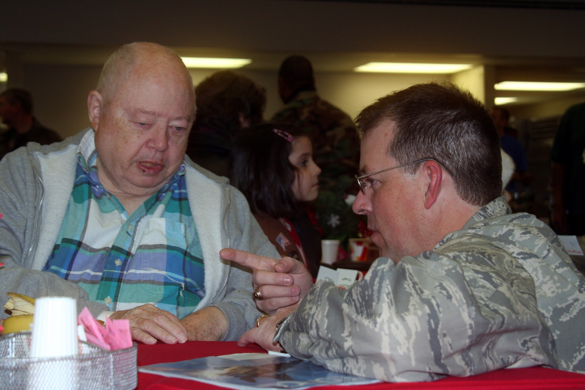 WRIGHT-PATTERSON AFB, Ohio - Chaplain (Maj.) William Dickens, 445th Airlift Wing, visits with Mr. Harold Snyder, who was an Air Force Corporal, at the Dayton VA Medical Center in Dayton, Ohio during the annual Christmas party.  The 445th Airlift Wing has been involved with the VA Christmas celebration for 12 years. (Air Force photo/Capt. Caroline Wellman)  