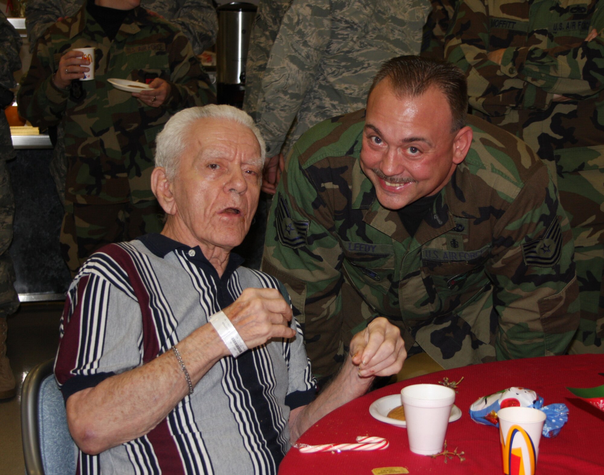 WRIGHT-PATTERSON AFB, Ohio - Tech. Sgt. Tim Leedy, 445th Operation Support Squadron, visits with Mr. James Gray at the Dayton VA Medical Center in Dayton, Ohio during the annual Christmas party.  Mr. Gray is Sergeant Leedy's grandfather and was a POW in Germany during World War II.  The 445th Airlift Wing has been involved with the VA Christmas celebration for 12 years. (Air Force photo/Capt. Caroline Wellman)  