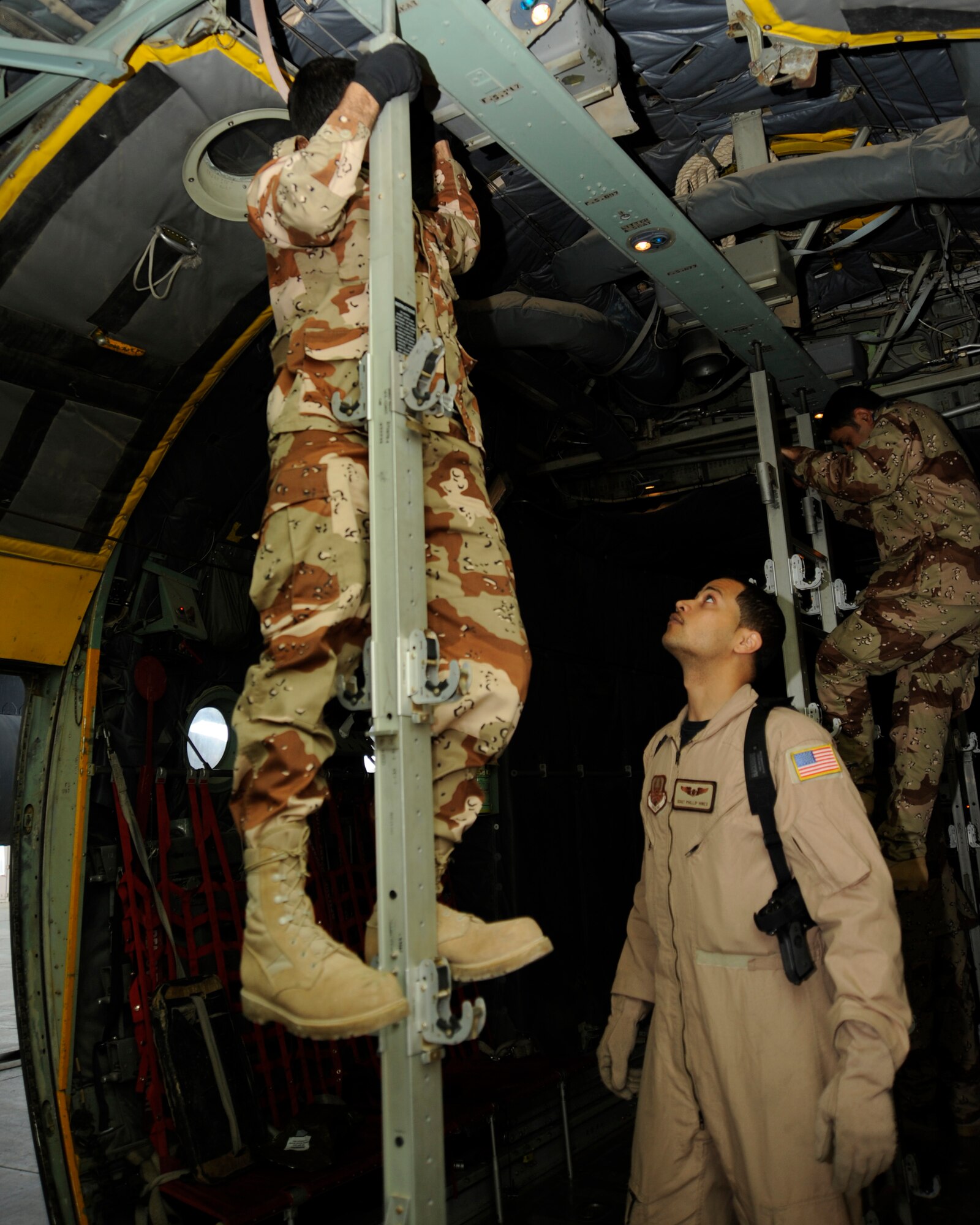 U.S. Air Force Staff Sgt. Phillip Hines, aero-medical evacuation instructor, ensures an Iraqi air force medic reconfigures a C130 Hercules aircraft correctly for patient transport during a patient movement exercise at New Al-Muthana Air Base, Iraq on Dec. 3. Hines, a Kaiserslautern, Germany native, is deployed from the USAF School of Aerospace Medicine in San Antonio, Texas. (U.S. Air Force photo/Staff Sgt. Paul Villanueva II)