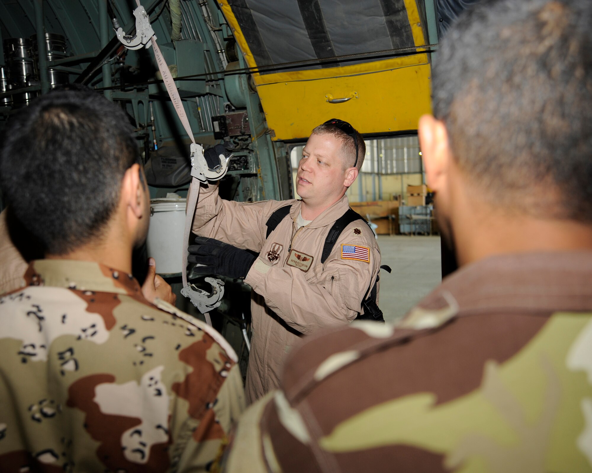 U.S. Air Force Maj. Bryan Hutcheson, aero-medical evacuation basics course director, shows how to inspect the different parts used to secure litters in a C130 Hercules aircraft at New Al-Muthana Air Base, Iraq on Dec. 3. Hutcheson, a Kansas City, Mo. native, is deployed from the USAF School of Aerospace Medicine in San Antonio, Texas. (U.S. Air Force photo/Staff Sgt. Paul Villanueva II)