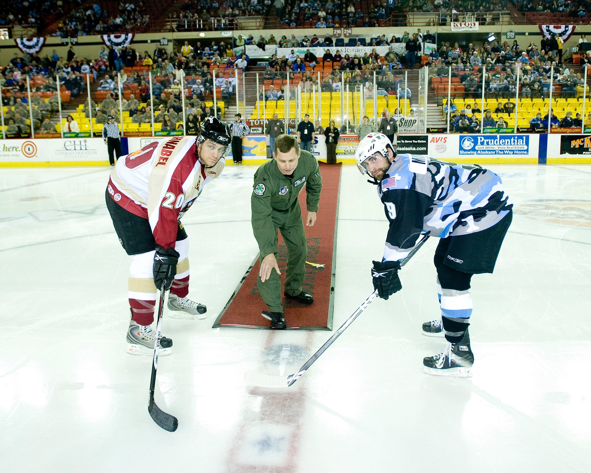 ANCHORAGE, Alaska -- Col. Thomas Bergeson, 3rd Wing commander, drops the ceremonial puck at Aces' military appreciation game Dec. 6. (U.S. Air Force photo/Senior Airman Jonathan Steffen)