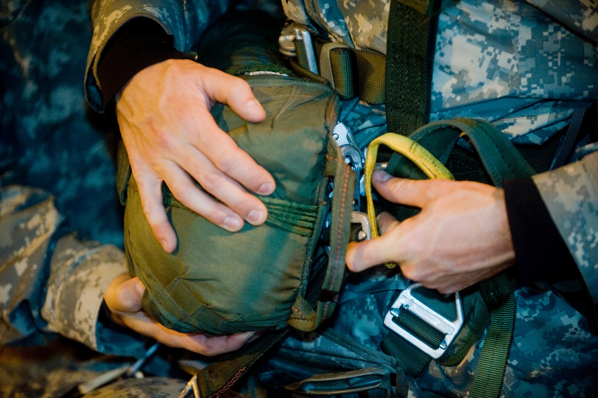 ELMENDORF AIR FORCE BASE, Alaska -- Soldiers from the 4-25 Brigade Special Troops Battalion put on an emergency parachute Dec. 5. The 4-25 BTSB uses this time to build up there parachutes prior to getting on the C-17 Globemaster III. (U.S. Air Force photo/Senior Airman Jonathan Steffen)