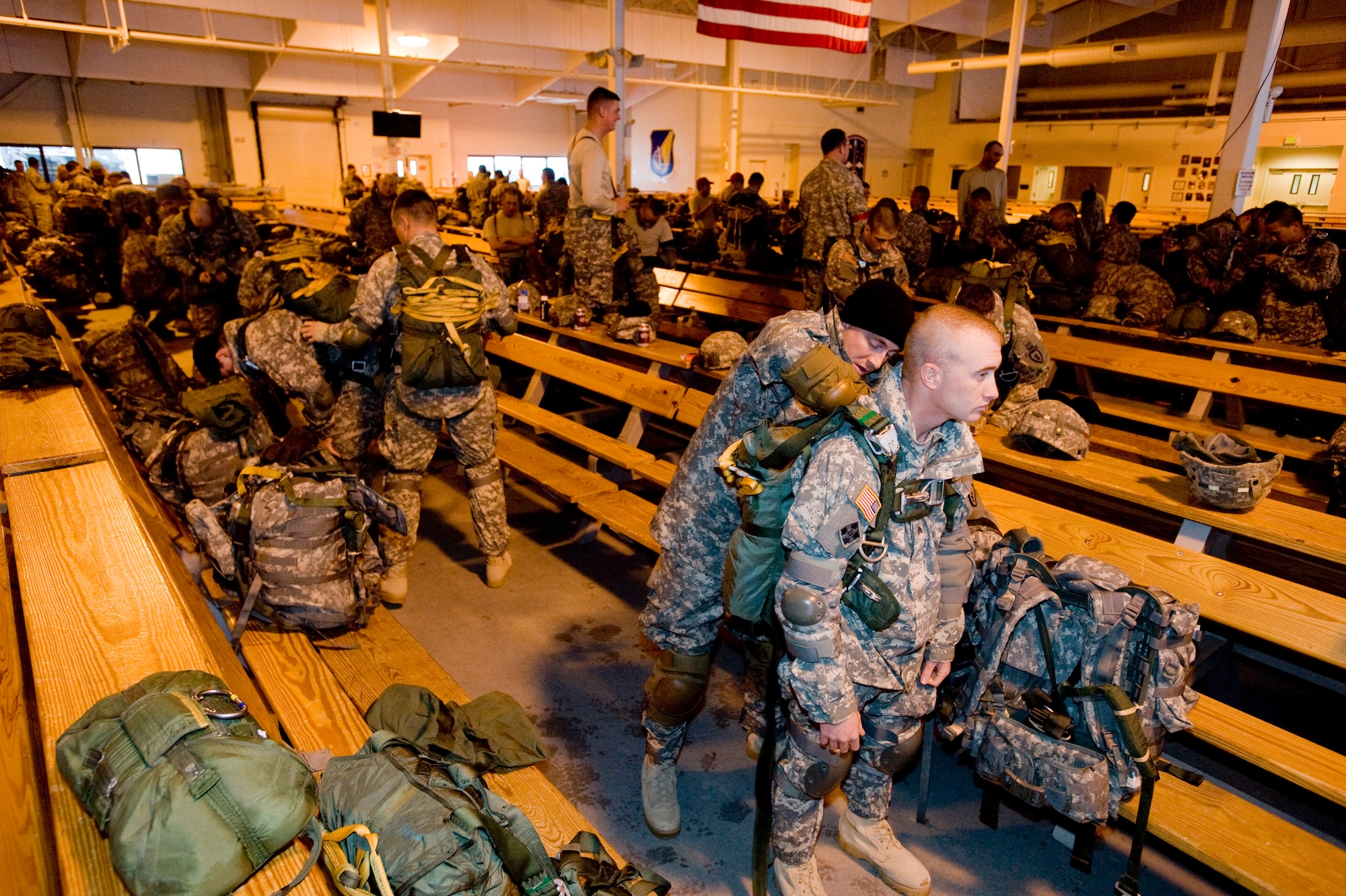 ELMENDORF AIR FORCE BASE, Alaska -- Army Staff Sgt. Richard Lampl helps Sgt. Justin Howard, 4-25 Brigade Special Troops Battalion, put on parachute Dec. 5. The 4-25 BTSB uses this time to build up there parachutes prior to getting on the C-17 Globemaster III. (U.S. Air Force photo/Senior Airman Jonathan Steffen)