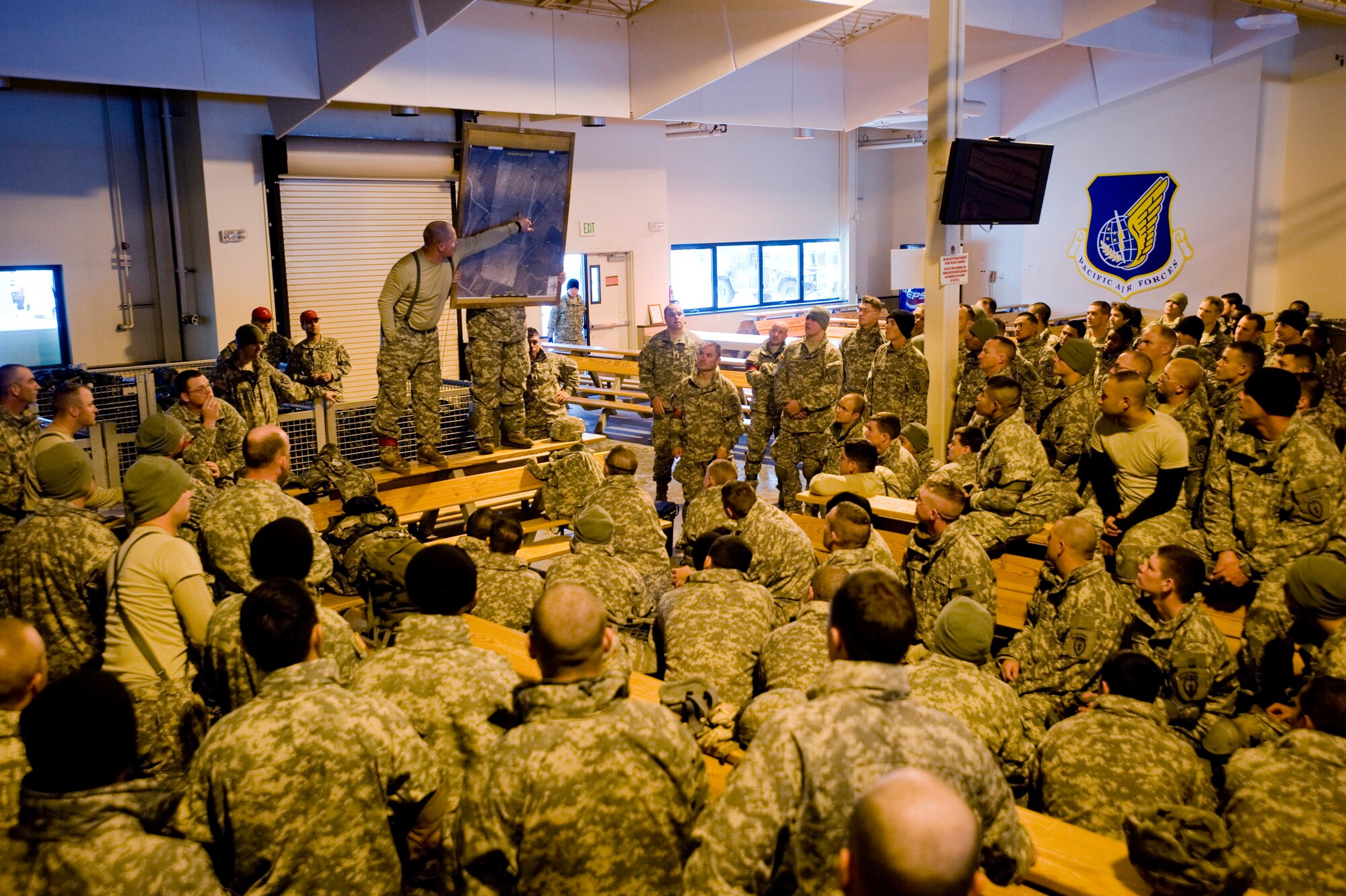 ELMENDORF AIR FORCE BASE -- Army 1st Sgt. Darrin Holiphant, 4-25 Brigade Special Troops Battalion, briefs the drop zone to the jumpers Dec. 5. The 4-25 BTSB uses this time to brief where to meet and what to do if jumpers land outside the drop point. (U.S. Air Force photo/Senior Airman Jonathan Steffen)