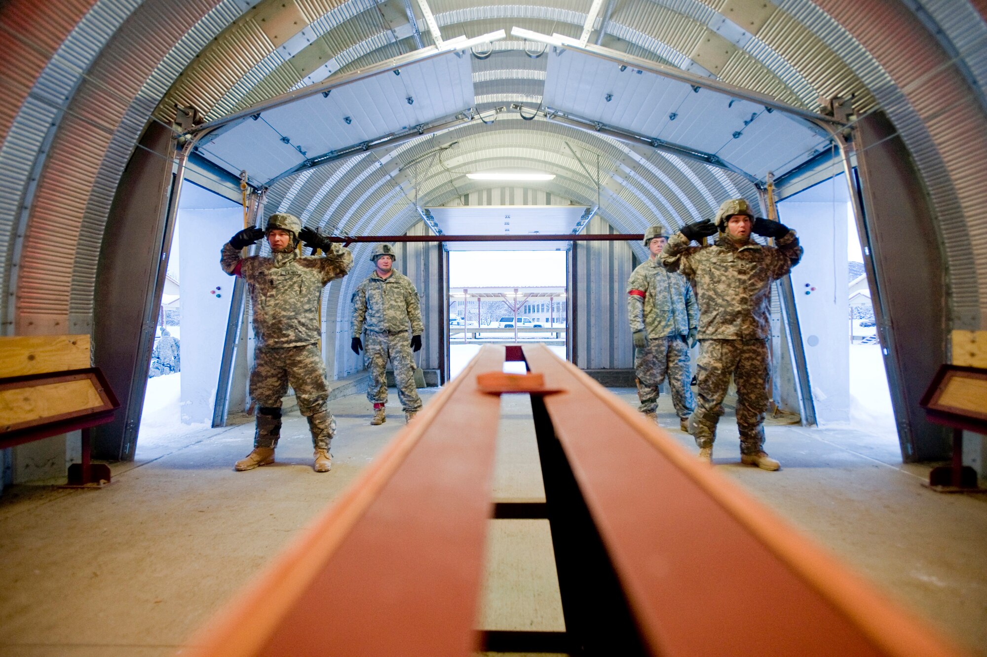 FORT RICHARDSON, Alaska -- Army 1st Sgt. Jerome Jones and Sgt. 1st Class Brian Zoleske 4-25 Brigade Special Troops Battalion jump masters, practice jump procedures at a mock door Dec. 5. The 4-25 BSTB has to go to Sustainment Airborne Training 24 hours prior to jumping. The sustainment training will go over jumping and landing procedures. (U.S. Air Force photo/Senior Airman Jonathan Steffen)