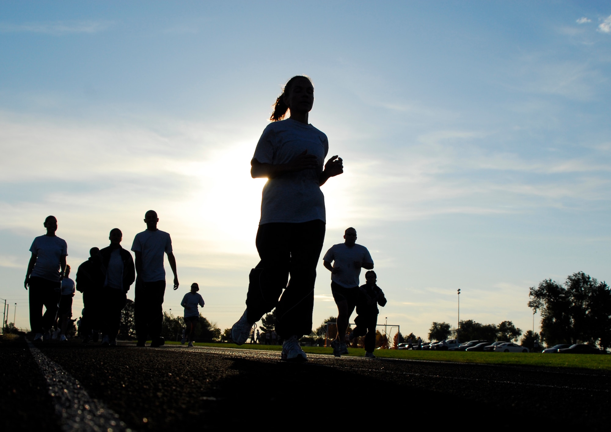 Airmen from the Air Reserve Personnel Center run the outdoor track at Buckley Air Force Base on Oct. 2. The track will be closed through Jan. 12, 2009, during installation of synthetic turf. (U.S. Air Force photo/Dwayne Beuthel)