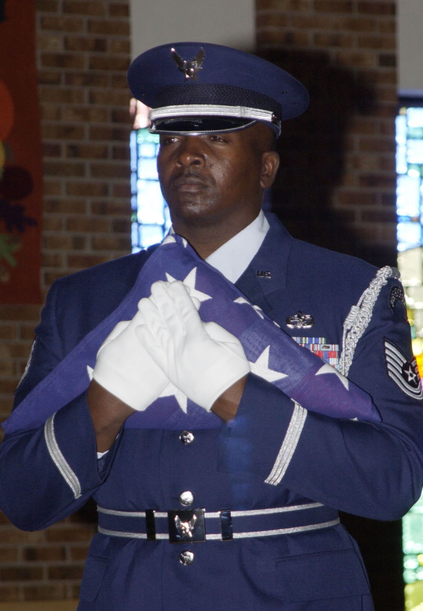 Tech. Sgt. Andrew Fulbright presents the American Flag as a member of the High Frontier Honor Guard team chief. Sergeant Fulbright, whose step-son is a member of the U.S. Air Force Academy's Falcon football in Colorado, attends all his Air Force home games. (U.S. Air Force photo)           