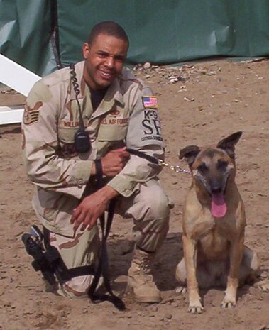 Staff Sgt. Kenneth Williams, a 99th Security Forces Military Working Dog section trainer,  takes a break mid-day with his canine partner, Kisma, while deployed to Manas Air Base, Kyrgyzstan in 2007. Kisma was Sergeant Williams’ first dog and partner for more than three years. (courtesy photo)