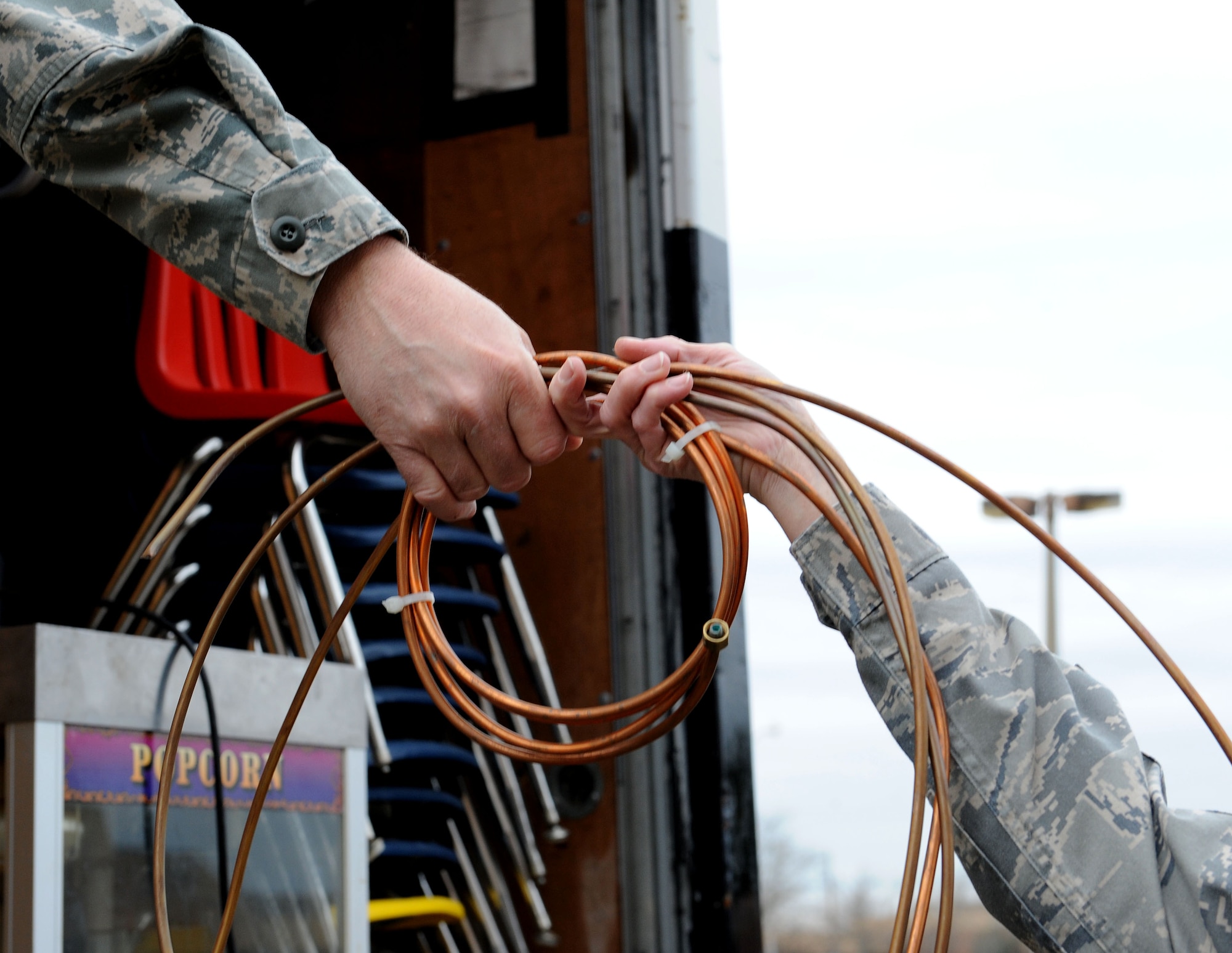 LANGLEY AIR FORCE BASE, Va. -- Airmen from the 83rd Network Operations Squadron load wire into a truck during the Airmen's Attic clean-out Dec. 5. Approximately 60 Airmen volunteered on the squadron's Wingman Day to move items to a storage facility allowing the Airmen's Attic to expand.  (U.S. Air Force photo/Airman Rebecca Montez)