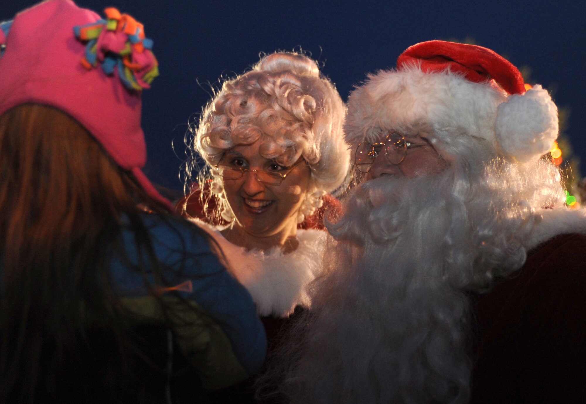 CANNON AIR FORCE BASE, N.M. - Santa and Mrs. Claus visit with children at Cannon during the annual tree lighting ceremony Dec. 4. Santa Claus arrived in a fire truck courtesy of the 27th Special Operations Civil Engineer Squadron. (U.S. Air Force photo/Airman 1st Class Evelyn Chavez)