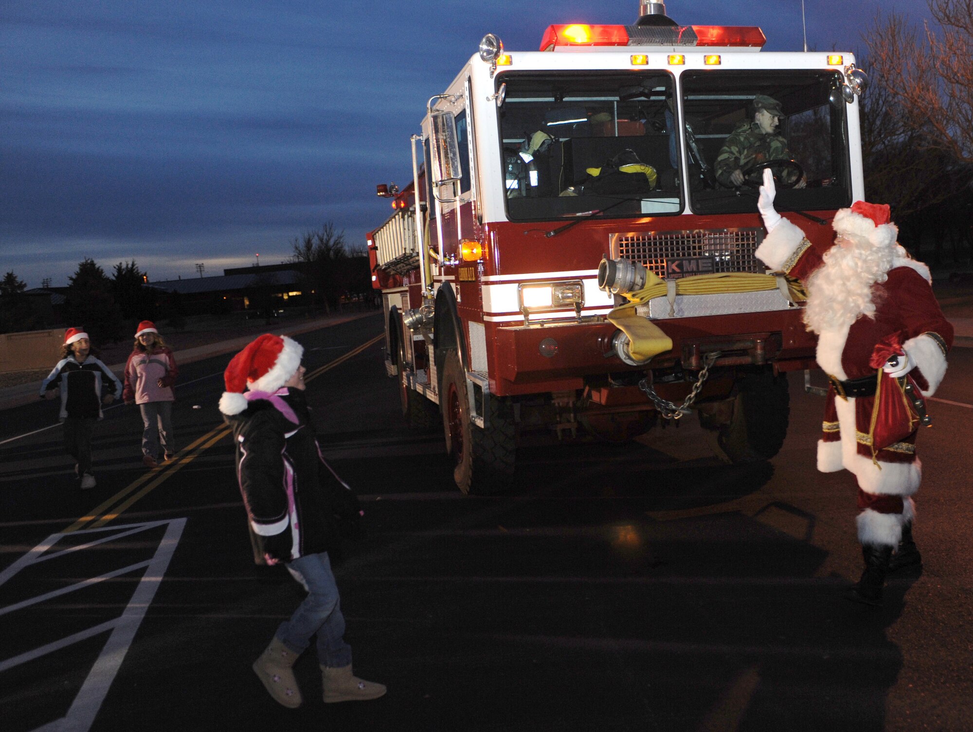 CANNON AIR FORCE BASE, N.M. - Santa visits with children at Cannon during the annual tree lighting ceremony Dec. 4. Santa Claus arrived in a fire truck courtesy of the 27th Special Operations Civil Engineer Squadron.  (U.S. Air Force photo/Airman 1st Class Evelyn Chavez)