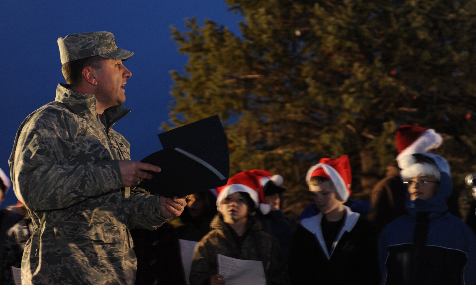 CANNON AIR FORCE BASE, N.M. - Col. Timothy Leahy, 27th Special Operations Wing commander, makes a speech during the annual base tree lighting ceremony Dec. 4. Children from the Ranchvale Elementary School choir caroled for the tree lighting event. (U.S. Air Force photo/Airman 1st Class Evelyn Chavez)