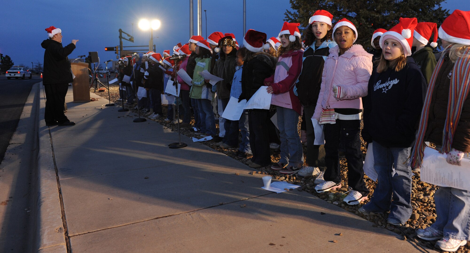 CANNON AIR FORCE BASE, N.M. - Children from the Ranchvale Elementary School choir carol during the annual base tree lighting ceremony Dec. 4. Children also received a visit from Santa and Mrs. Claus. (U.S. Air Force photo/Airman 1st Class Evelyn Chavez)