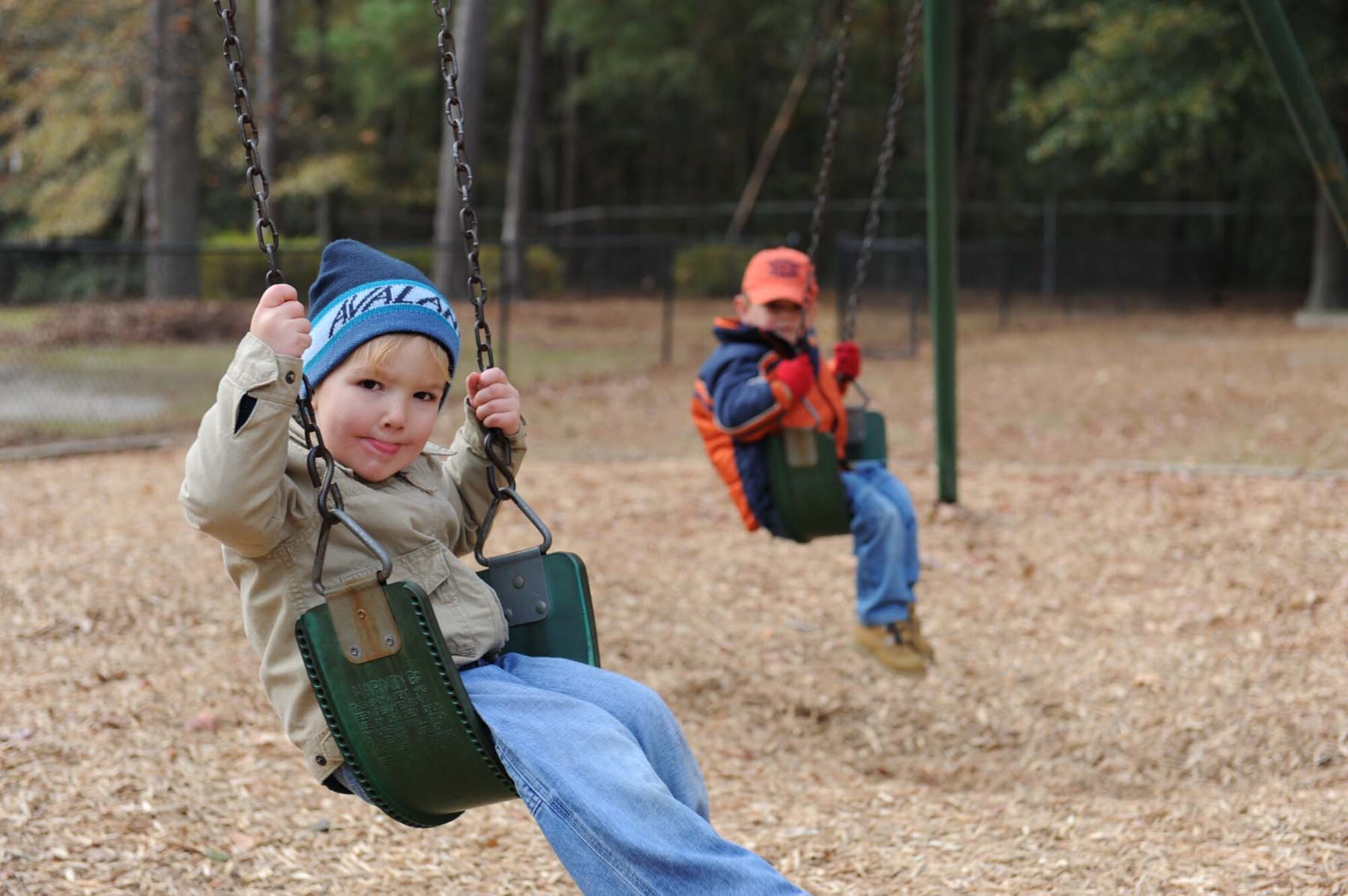 SHAW AIR FORCE BASE, SC -- Chase Denton, son of MasterSgt Harold Denton, and Bryce Johnson, son of MasterSgt James Johnson, swing on the playground at the city of Sumter's Swan Lake for Hearts Apart on December 6, 2008. Hearts Apart is organized by the Shaw AFB Airmen and Family Readiness Center to help spouses during deployments. (U.S. Air Force photo/ Senior Airman Matthew Davis)