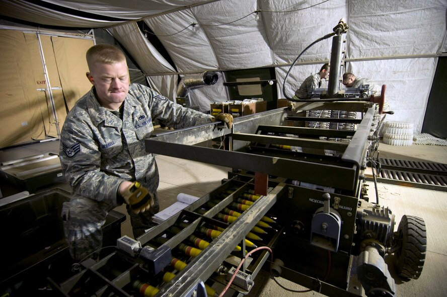 Staff Sgt. James Jerrell inspects 30mm round as they are processed through a GFU-7 "Dragon" Dec. 2 at Bagram Air Field, Afghanistan. He also makes sure that they are re-inserted into their linked tube carriers correctly with no gaps. Sergeant Jerrell is deployed from Moody Air Force Base, Ga., and hails from Fort Smith, Ark. (U.S. Air Force photo/Staff Sgt. Samuel Morse) 