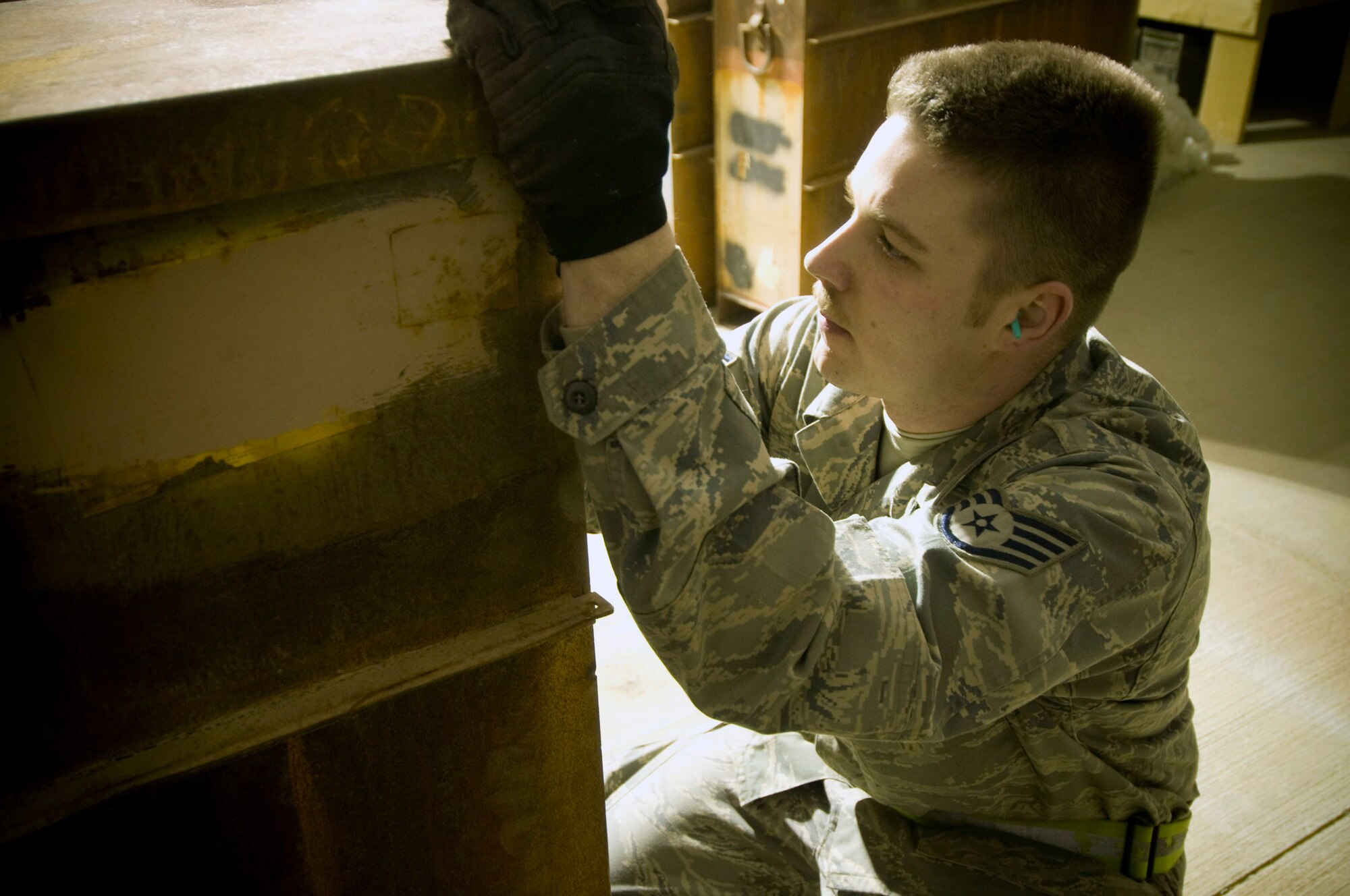 Staff Sgt. Erik Thomas writes the lot number and number of processed rounds on a container Dec. 2 at Bagram Airfield, Afghanistan. These highly explosive rounds must be carefully tracked to ensure total accountability. Sergeant Thomas is deployed from Mountain Home Air Force Base, Idaho, and hails from Bennington, Vt. (U.S. Air Force photo/Staff Sgt. Samuel Morse) 