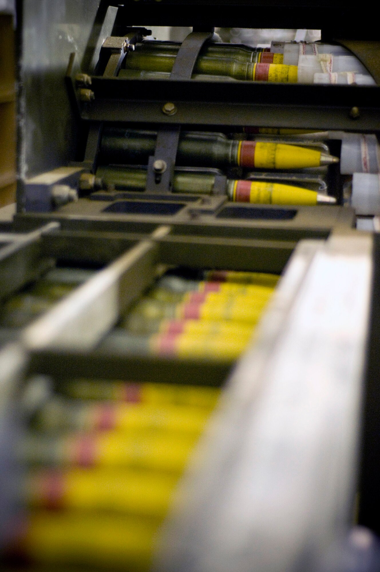 30mm high-explosive incendiary rounds feed through a GFU-7 "Dragon" during processing Dec. 2 at Bagram Airfield, Afghanistan. Members of the 455th Expeditionary Maintenance Squadron Ammo Flight use the GFU-7 to inspect rounds that form the backbone of the A-10 Thunderbolt II's armament and ready them for seamless loading into the aircraft. (U.S. Air Force photo/Staff Sgt. Samuel Morse) 
