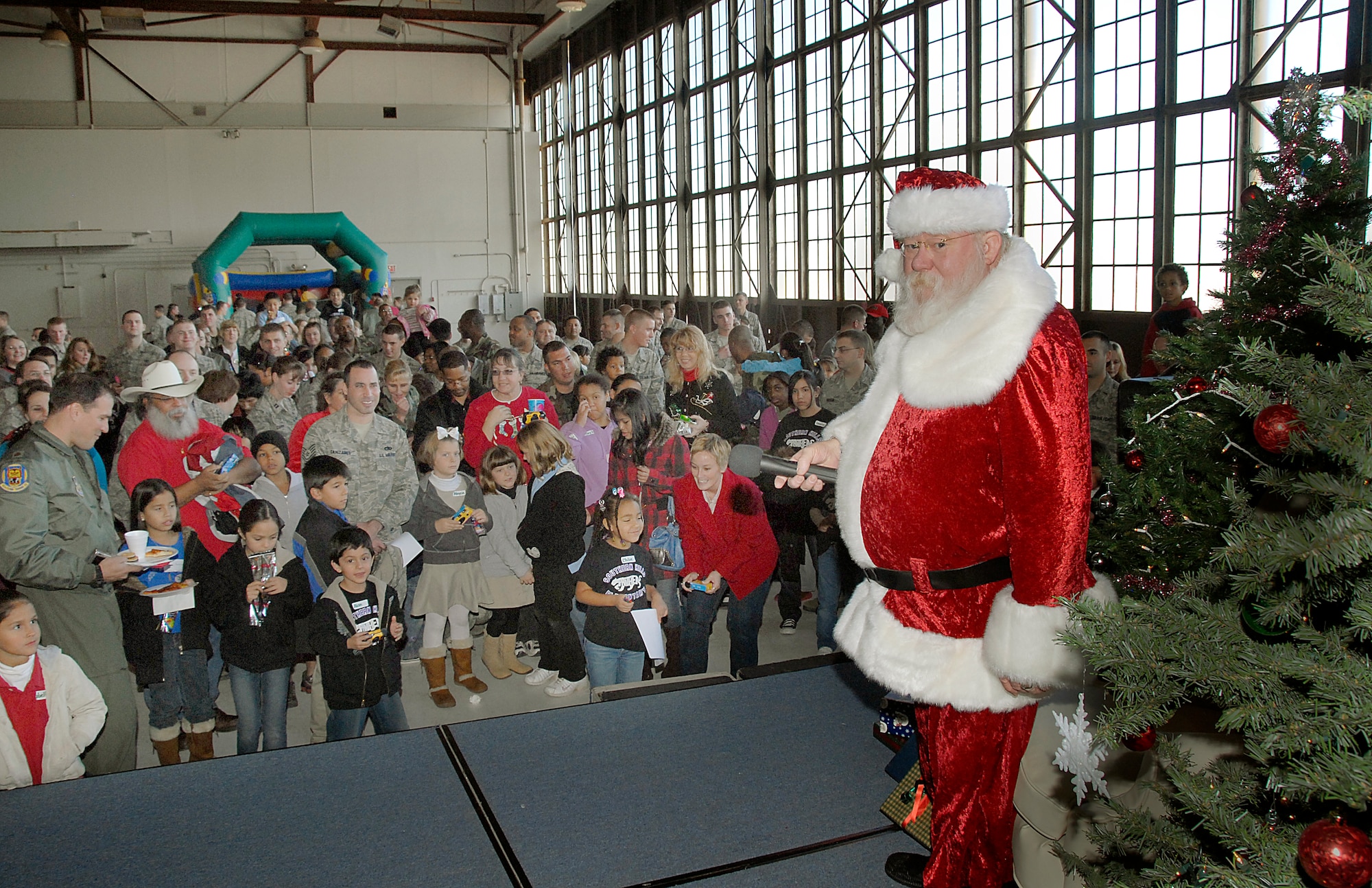 Santa Claus prepares to address the crowd inside hangar 1090 on Sheppard Air Force Base Dec. 5 after arriving at the Give A Child A Christmas event.  (U.S. Air Force photo/Harry Tonemah)
