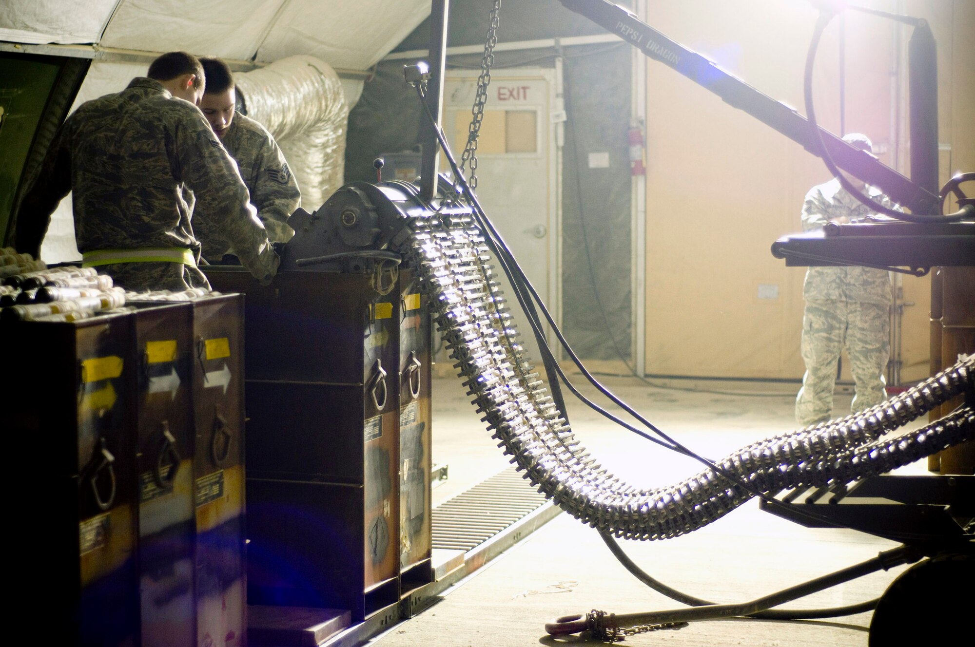Airmen of the 455th Expeditionary Maintenance Squadron Ammo Flight process and inspect 30mm rounds in a GFU-7 "Dragon" Dec. 2 at Bagram Airfield, Afghanistan. The process ensures the right number of rounds go into each canister with no gaps in the chain of linked tube carriers. (U.S. Air Force photo/Staff Sgt. Samuel Morse) 