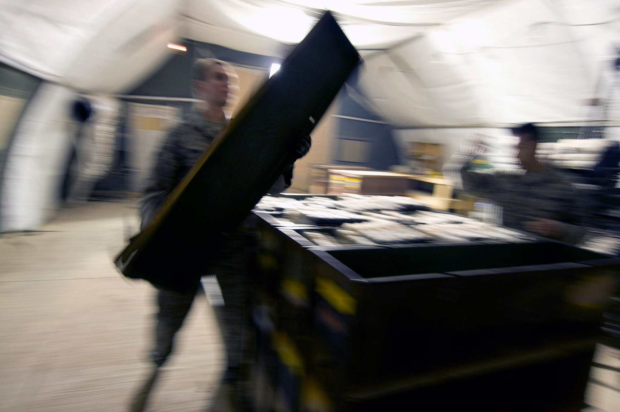 Airman 1st Class Jeb Snow removes the lid from an ammo container at Dec. 2 Bagram Airfield, Afghanistan. Airman Snow is a 455th Expeditionary Maintenance Squadron munitions systems apprentice deployed from Mountain Home Air Force Base, Idaho. He hails from Wasilla, Alaska. (U.S. Air Force photo/Staff Sgt. Samuel Morse)