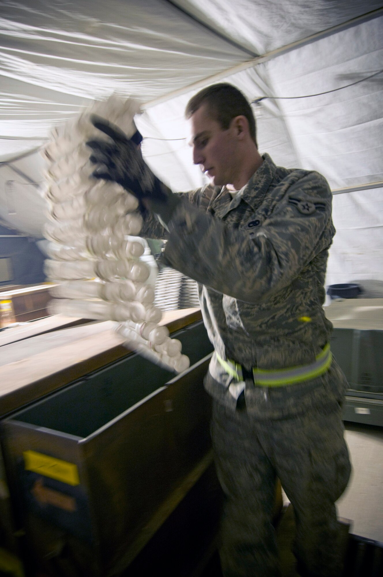 Airman 1st Class Jeb Snow prepares linked tube carriers for processing Dec. 2 at Bagram Airfield, Afghanistan. Airman Snow is deployed from Mountain Home Air Force Base, Idaho, and hails from Wasilla, Alaska. Airman Snow is a 455th Expeditionary Maintenance Squadron munitions systems apprentice. (U.S. Air Force photo/Staff Sgt. Samuel Morse)