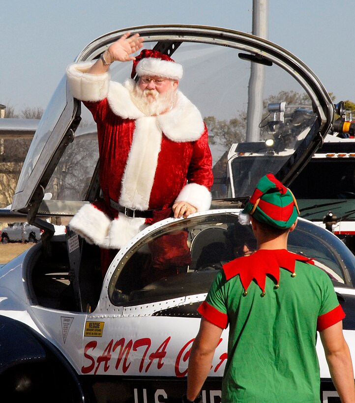 Santa Claus arrives in a T-37 at hangar 1090 Friday afternoon to talk to all the boys and girls at the Give a Child a Christmas event held in Hangar 1090 Dec. 5. (U.S. Air Force photo/Harry Tonemah)