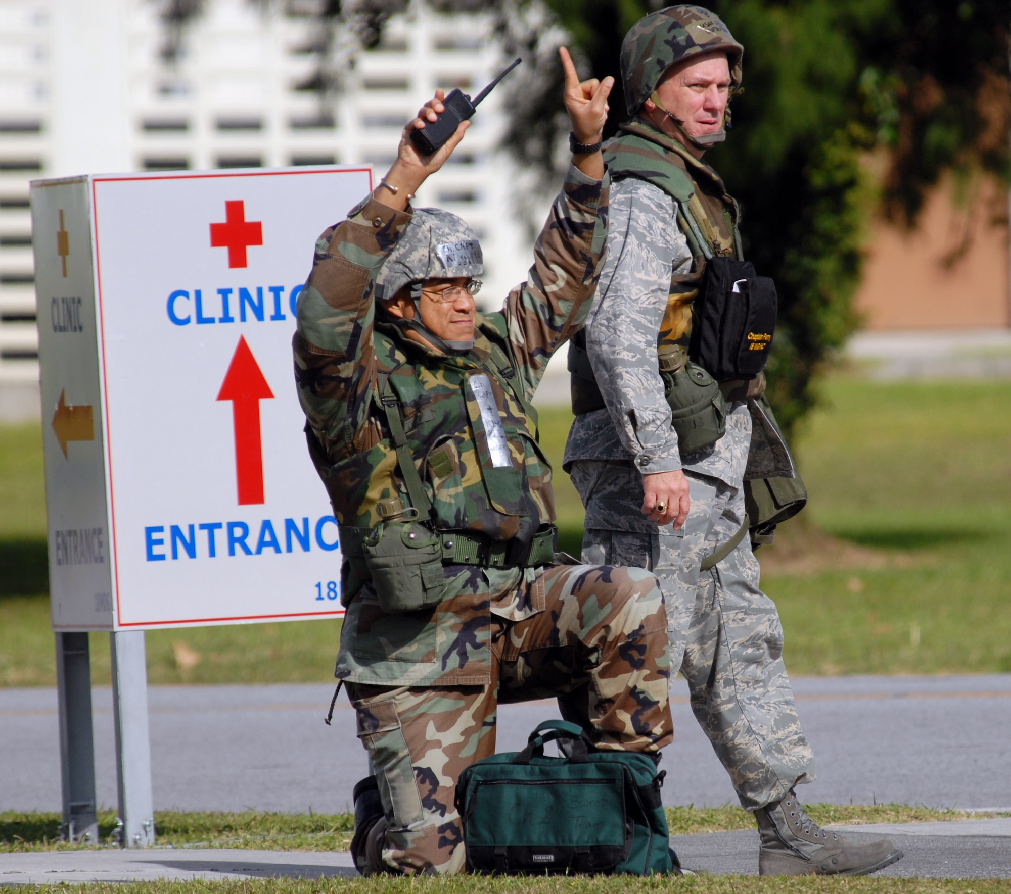 Chaplain (Capt.) Martin King (left) and Chaplain (Col.) Clifton Perry set up a cordon after discovering a simulated unexploded ordnance outside Chapel 2 Dec. 4 at Kadena Air Base, Japan. The scenario is part of Exercise Beverly High 09-01, a joint Air Force-Marine Corps exercise designed to test the ability of both services to execute their critical missions under simulated combat conditions. (U.S. Air Force photo/Airman 1st Class Chad Warren) 
