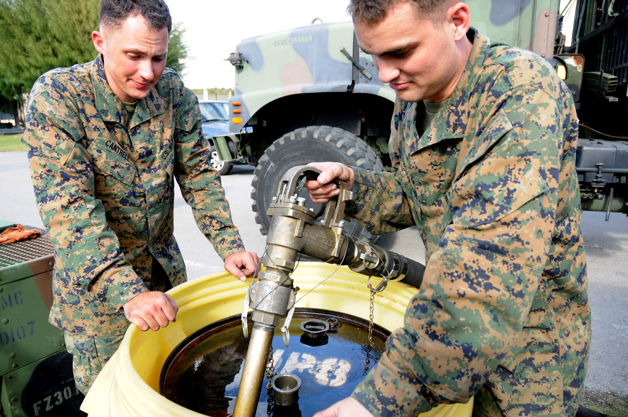 Marine Cpl. Matthew Cantrell (left) and Marine Lance Cpl. Ryan Zimmerman refuel a generator during Exercise Beverly High 09-01 Dec. 4 at Kadena Air Base, Japan. The joint Air Force-Marine Corps exercise, tested the ability of both services to execute their critical missions under simulated combat conditions. The Marines are from the both from the Marine Wing Support Squadron-172. (U.S. Air Force photo/Airman 1st Class Amanda Grabiec) 
