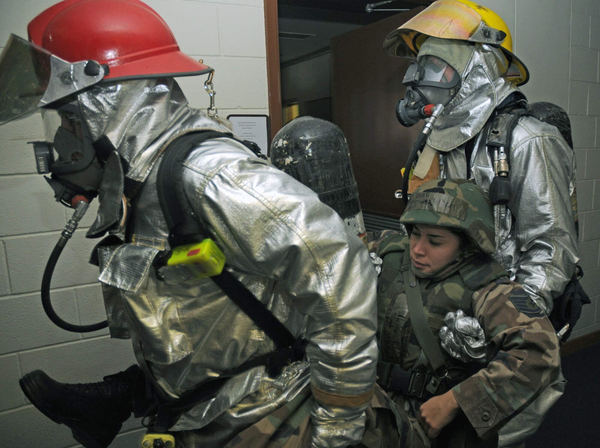 Firefighters from the 18th Civil Engineer Squadron remove an injured person from a building following a simulated missile strike Dec. 3 at Kadena Air Base, Japan. The simulation is part of Exercise Beverly High 09-01, a joint Air Force-Marine Corps exercise designed to test the ability of both services to execute their critical missions under simulated combat conditions. (U.S. Air Force photo/Airman 1st Class Chad Warren) 
