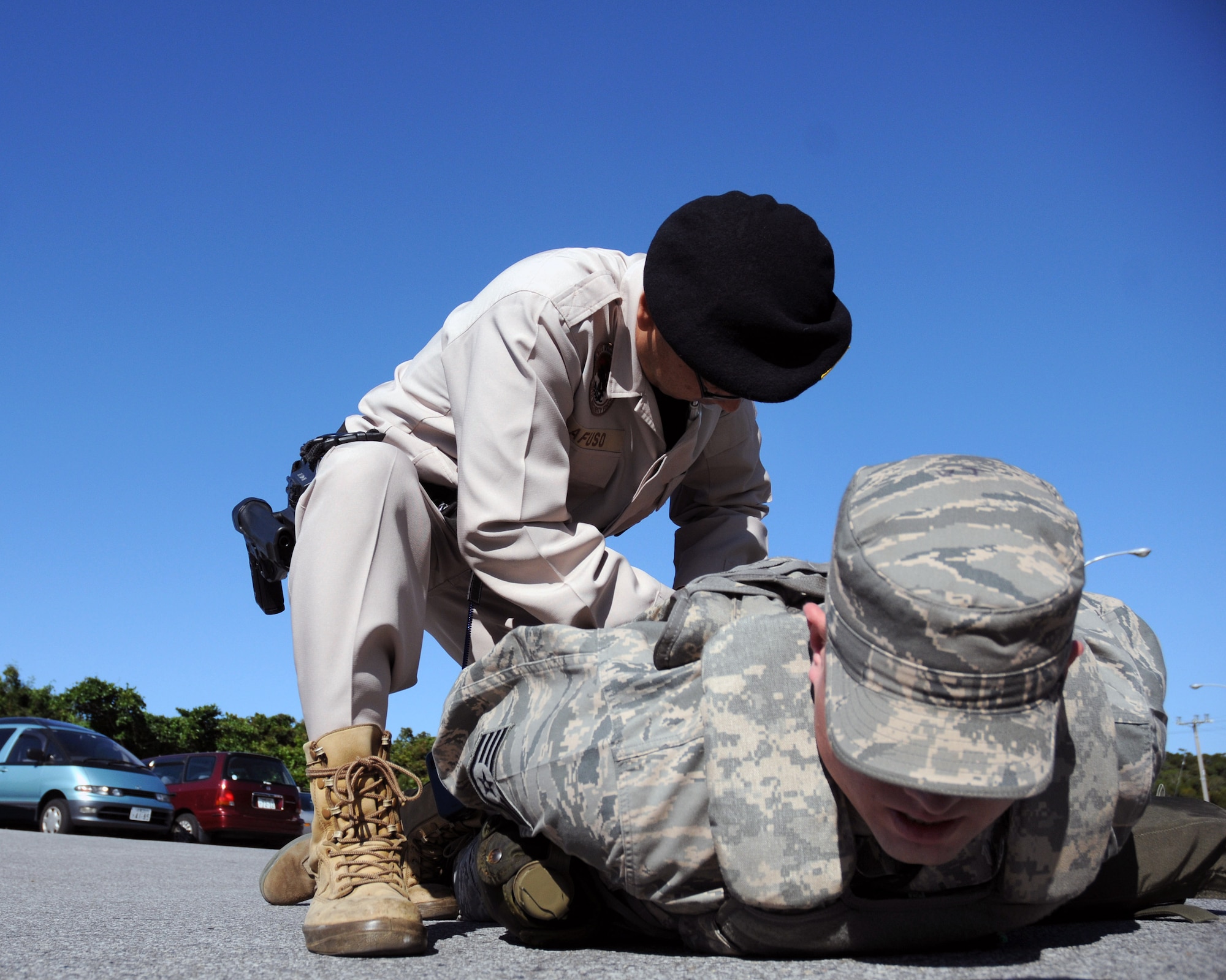 Staff Sgt. James Kipp is apprehended by Makoto Afuso for entering a restricted area without proper identification during an exercise scenario Dec 3 at Kadena Air Base, Japan. Both men are assigned to the 18th Security Forces Squadron. The scenario is part of Exercise Beverly High 09-01, a joint Air Force-Marine Corps exercise designed to test the ability of both services to execute their critical missions under simulated combat conditions. (U.S. Air Force photo/Airman 1st Class Amanda Grabiec) 
