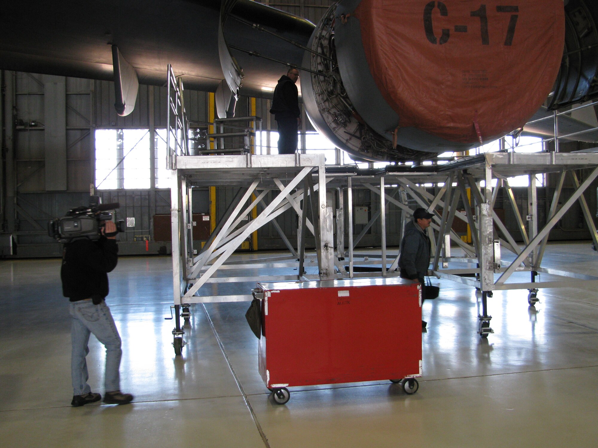 Mechanics from the 97th Maintenance Directorate show Channel 7 reporters the C-17 engine maintenance stands designed by Mr. Ramon Terrazas (bottom) and Mr. Mike Schlup (top) (U.S. Air Force photo/Mr. David L. Fortuna)