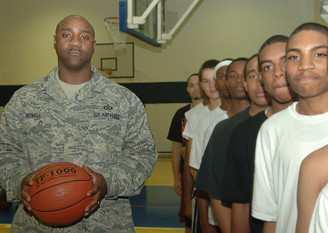 Senior Master Sgt. Joseph Howell, 39th Air Base Wing Command Post superintendent and one of four Incirlik chief-selects, stands with members of the Injirlik Unified School Hodjas, a basketball team comprised of male IUS students. Sergeant Howell is the team’s head coach. (U.S. Air Force photo illustration by Tech. Sergeant Ray Bowden)
