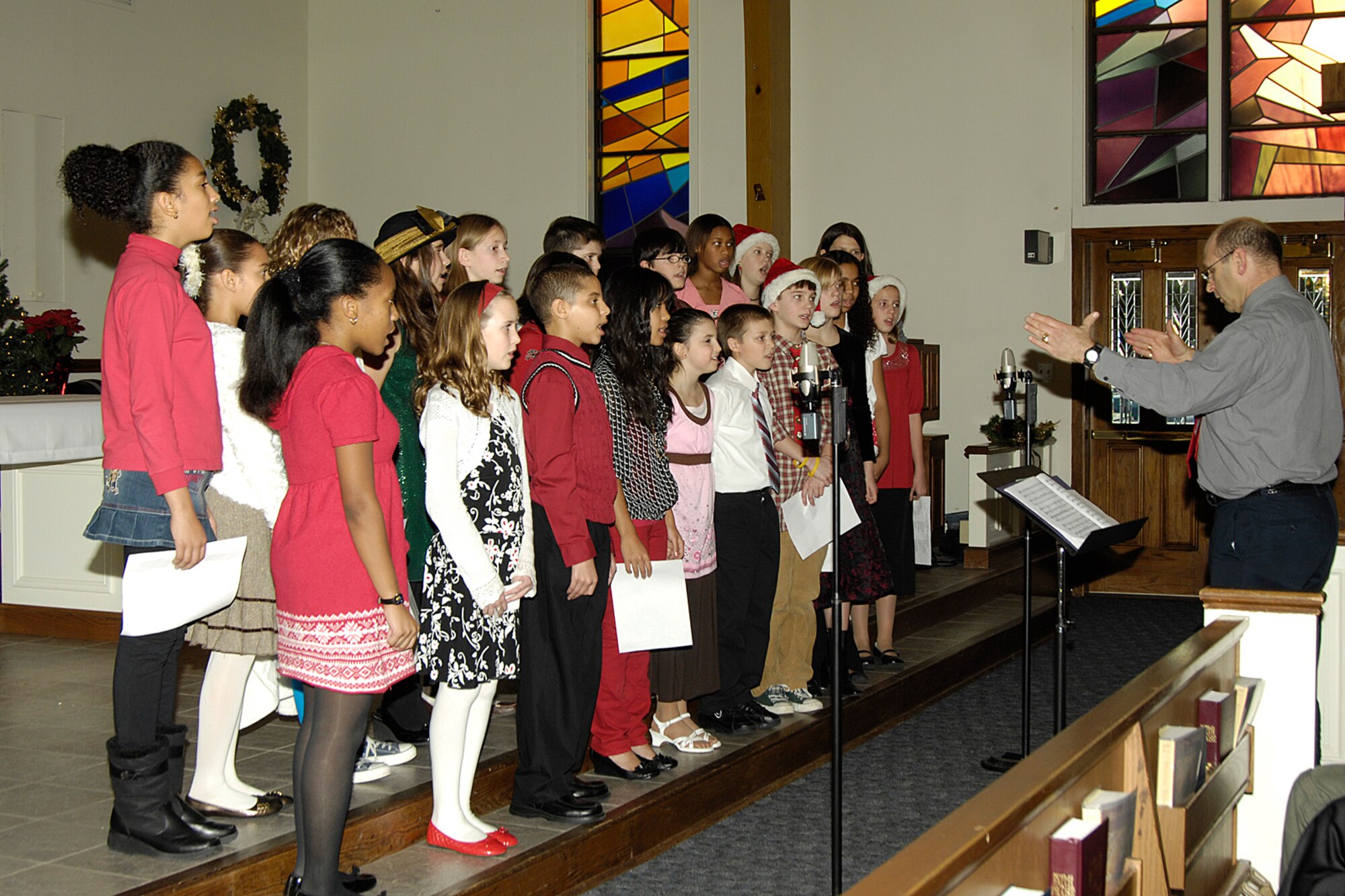 HANSCOM AIR FORCE BASE, Mass. – Members of the Hanscom Middle School chorus, directed by Howard Worona, perform inside the Base Chapel during the base tree lighting ceremony that took place on Dec. 3. (U.S. Air Force photo by Linda LaBonte Britt)